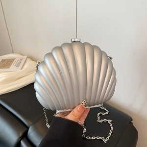 Elegant silver shell clutch bag with vertical ridges and a metallic chain strap