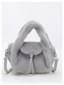 Close-up of grey fluffy faux fur handbag featuring soft plush texture and silver metal buckles