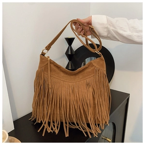 Close-up of brown suede fringe shoulder bag with long tassels and gold metal hardware