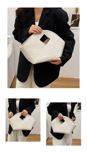Detail of white woven hobo bag showing faux leather texture and square cutout handle