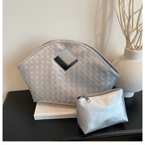 Silver woven tote bag and matching clutch set with hollow handle and metallic finish