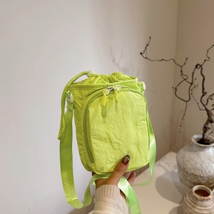 Neon green nylon drawstring crossbody bag with front zipper pocket for outdoor sports