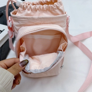 Pink nylon crossbody bag with drawstring closure and mesh zipper pocket for outdoor sports