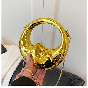 Polished gold metal half-moon evening bag with wavy top handle and chain strap