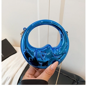 Metallic blue crescent handbag with circular handle and gold chain strap for party