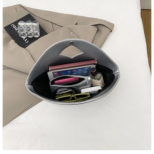 Spacious interior of silver triangular tote bag showing capacity for tablets and daily items