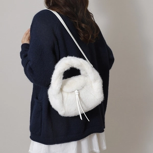 White faux fur tote bag with plush handle and leather strap for winter style