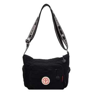 Front view of black washed fabric crossbody bag with multiple pockets and wide strap
