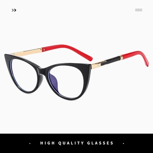 Detail shot of cat eye glasses featuring black frames with gold metal temples