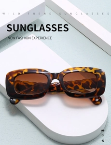 Detail of tortoise shell sunglasses with thick chain temple on minimalist display
