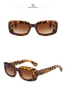 Detail view of tortoiseshell rectangle sunglasses with twisted woven temple design