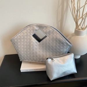 Silver woven tote bag with matching inner pouch in minimalist aesthetic and metallic finish
