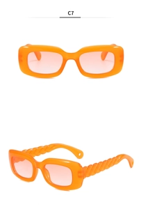 Close-up of orange rectangle sunglasses featuring unique spiral twisted temple design