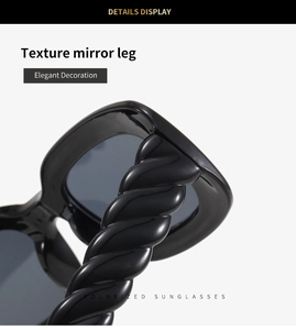 Detail of black polarized sunglasses featuring unique spiral twist texture on the temples
