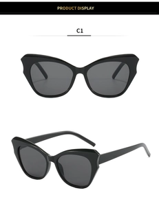 Detail view of glossy black cat-eye sunglasses with dark grey lenses in C1 color
