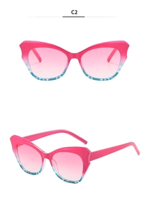 Cat eye sunglasses detail with magenta and blue gradient frames and pink lenses