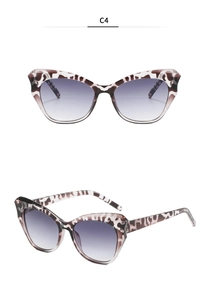Detail view of cat eye sunglasses in leopard tortoiseshell with purple gradient lenses