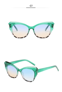 Detail of green cat-eye sunglasses with tortoiseshell accents and gradient blue-orange lenses