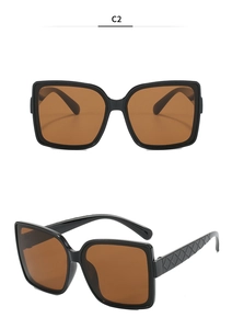 Detailed view of oversized square sunglasses featuring unique quilted embossed temples