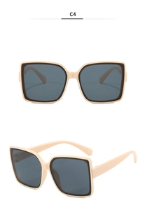 Detail of beige square oversized sunglasses featuring textured quilted temples and dark lenses