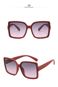 Detail of red oversized square sunglasses with textured temples and gradient purple lenses