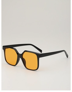 Detail view of bold black square frame sunglasses with vibrant orange tinted lenses