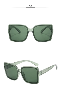 Detailed macro view of square white sunglasses with green lenses and textured temples