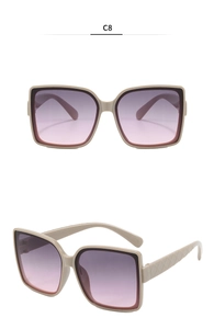 Detail view of large beige sunglasses with gradient purple lenses and quilted temple texture