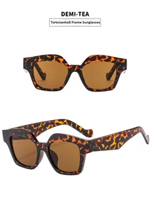 Detail view of demi-tea tortoiseshell cat eye sunglasses with brown tinted lenses