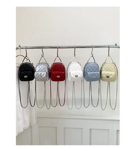 Detailed display of six colorful quilted mini backpacks with silver chain straps and locks