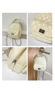 Detail view of cream quilted mini backpack with silver hardware and chain straps