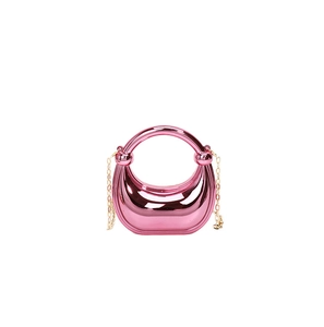 Detailed view of the rose gold acrylic moon bag with metallic finish and gold chain