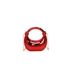 Mini red acrylic crescent bag with golden chain strap and integrated round handle