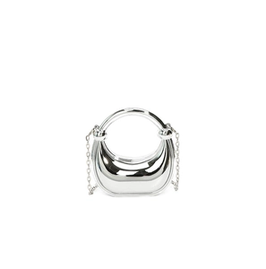 Close-up of polished silver acrylic crescent evening bag with mirror finish and handle