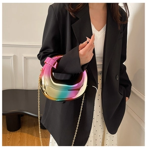 Macro detail of crescent acrylic evening bag with rainbow metallic gradient and chain