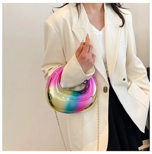 Close-up of rainbow gradient acrylic box clutch bag with metallic finish and gold chain