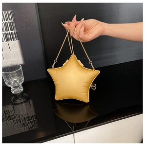 Detail of star-shaped golden chain bag featuring 3D embossed texture and metallic finish