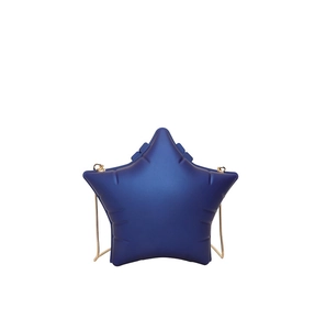 Detailed close-up of dark blue star-shaped bag with gold chain strap and stitching