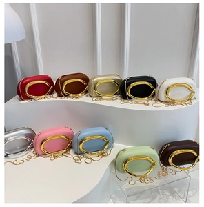 Detailed display of assorted colorful mini chain bags featuring iconic metallic C-clasp buckle