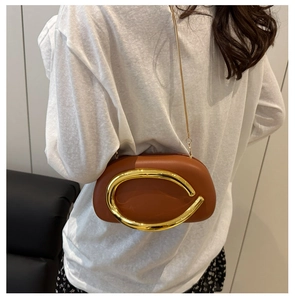 Brown round acrylic evening bag with oversized gold metal ring handle and fine chain strap