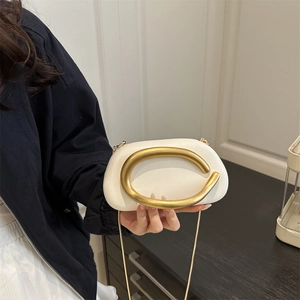 Chic white semi-circular PU crossbody bag with large gold C-shaped metal handle and chain