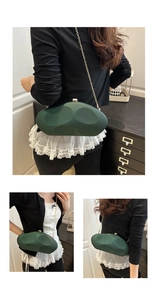 Detail of dark green acrylic clutch with gold chain and unique circular matte texture