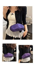 Detail of purple acrylic irregular stone evening bag with sleek gold metal chain strap