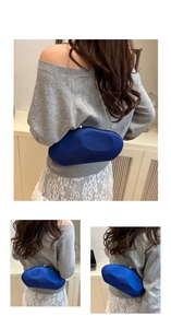 Detailed back view of deep blue evening bag with gold chain and matte pebble texture