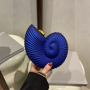 Chic royal blue conch shell evening clutch with gold chain and spiral texture finish