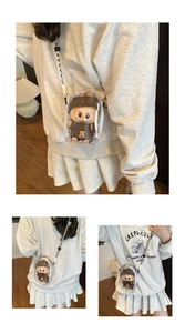 Detailed view of clear PVC jelly bag with mini Labubu plush and braided strap