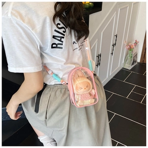 Detail view of pink candy-colored PVC jelly bag with plush bunny inside on model