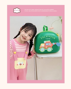 Detail of green EVA hardshell kids backpack with cartoon excavator design on a child