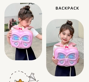 Side view of a 3D butterfly toddler backpack worn by a girl against a minimalist wall