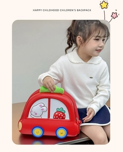 Detail of red car-shaped EVA hardshell backpack featuring cute cartoon rabbit and strawberry